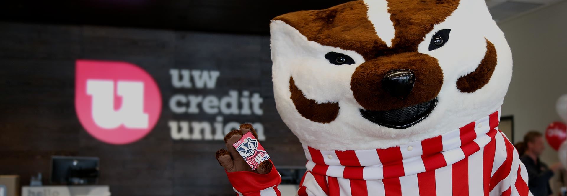 Bucky the Badger, the UW Madison mascot, is pictured holding up a debit card with his image on it.