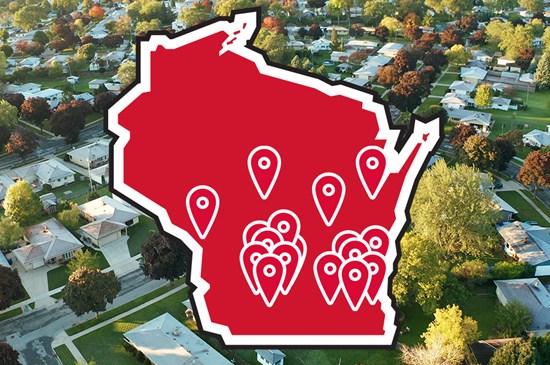 A graphic illustration of the state of Wisconsin dotted with markers representing UW Credit Union branch locations. The graphic is overlayed onto a photo of a suburban neighborhood taken from above.