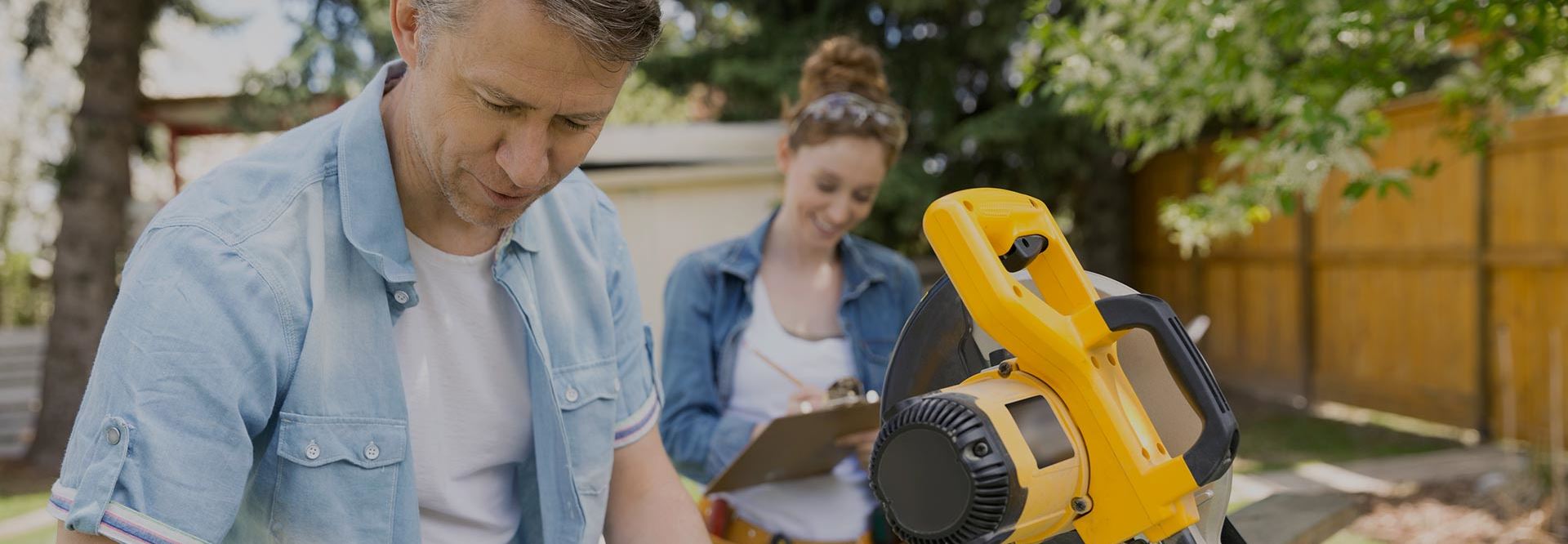Couple does a home improvement project outside after securing financing using their home equity.