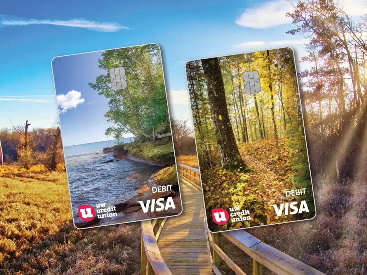 An image featuring two new nature inspired UW Credit Union debit card designs over a boardwalk trail backdrop. 